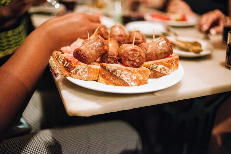 Barcelona: Tapas, Wine & History Tour of the Old Town - Stop 1 near Palau de la Balmesiana: meeting point and first impressions