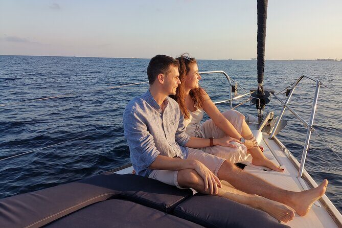 Sunset Sailboat Tour along the Coast with Open Bar - Stop-by-Stop: Famous Beach, Montjuïc Views, and a Monument From the Water